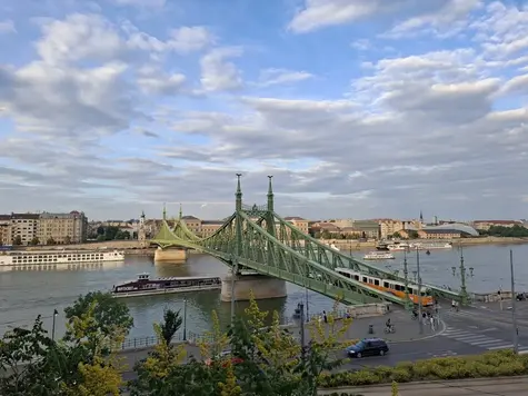 Veduta panoramica del Ponte della Libertà a Budapest con un tipico tram giallo che lo attraversa sul fiume Danubio