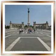 Piazza degli Eroi a Budapest con pavimentazione geometrica in primo piano e Monumento del Millennio sotto il cielo sereno